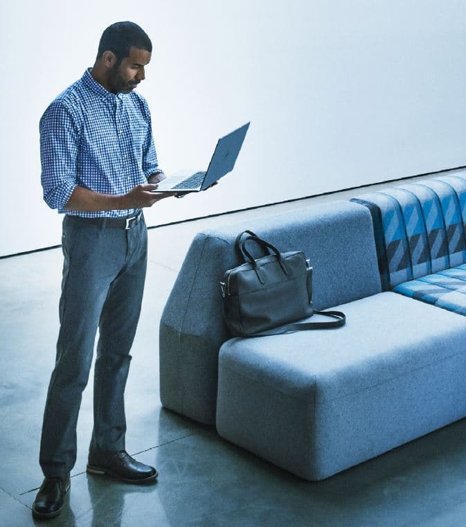 An employee works on his laptop